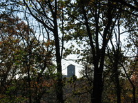 Inwood Hill Park: a view of the Cloisters museum through the trees.