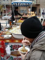 Philip digs into an interesting bowl of chick peas, noodles, mutton fat, and spices. Actually pretty tasty.