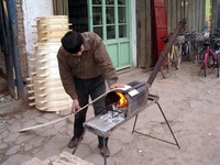 Making food-steaming baskets the simple way...fire plus wood.