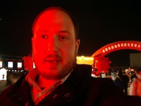 Self-portrait in the red glow of a huge lantern.