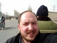 Riding on the back of motorcycle-cart taxi towards Korla's secondhand market.