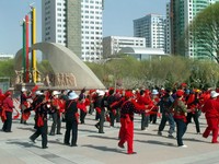 People like doing things in groups in China. Here, a group of older women practice synchronized dancing in Korla's Renmin Square.