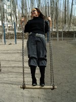 Tian Ping (who is also Wang Laoshi's daughter) enjoys a swing ride before our ascent of Tiemenguan