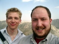 A self-portrait of myself and William, with Korla's mountains in the background.