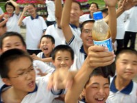 Go crazy! Students in front of a camera lense can't seem to control themselves. That's Baishi Kele (Pepsi Cola) being thrust in my face, by the way.