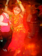A young girl, well-trained at Uyghur dancing, rules the dance floor.