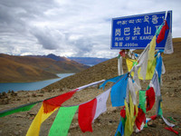 Looking over a slender blue arm of Yamdroktso Lake from the peak of Mt. Kangbala, at almost 5000 meters. Damn you, clouds!