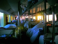 Sunrise, heading north on a sleeper bus somewhere between Urumqi (Wulumuqi) and Burqin (Buerjin). Those feet in the foreground belong to David Shallcross.