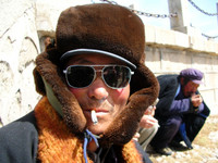 On the way to Qinghai Lake we stopped at some lackluster tourist trap where I snapped a shot of this Tibetan man enjoying a smoke.