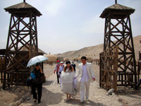 Where the Ming Dynasty Great Wall comes to an abrupt end near Jiayuguan, newlyweds prepares to take wedding photos.