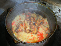 Mmmmm... lunch! Guzelnor's mother prepared us a big pot of polo (rice and carrots boiled for a long time with meat). It's usually made with mutton, but she used one of the family's chickens instead.