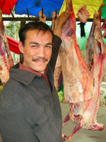 A Uyghur butcher who's proud of his meat at Kuqa's Friday bazaar.