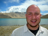 Me, at Lake Karakul with Mustagata in the background. Note the bald head and Uyghur-styled facial hair.