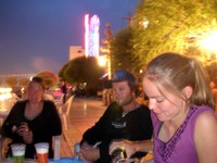 Kerryn Cockcroft (New Zealand), Jan (Carrie's Dutch boyfriend), and Carrie enjoy a beer by the river. Jan and Carrie had just returned from a mountain adventure in southwestern Xinjiang.
