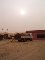 An outside view of the place I slept at in Tazhong, with the sun setting behind.