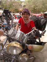 I managed to convince this cute little Uyghur girl to climb up on my motorcycle for a photo.