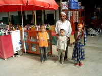 I stopped for an ice-cold drink and this man encouraged me to take a photo of him with some local children.