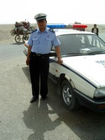I was stopped by the police between Keriya and Hotan, but after showing them my passport and NJ driver's license they let me keep going. One officer even let me snap a photo.