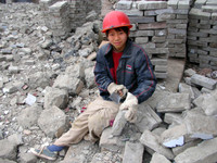 A young construction worker, helping to disassemble old Fengdu's buildings brick-by-brick.