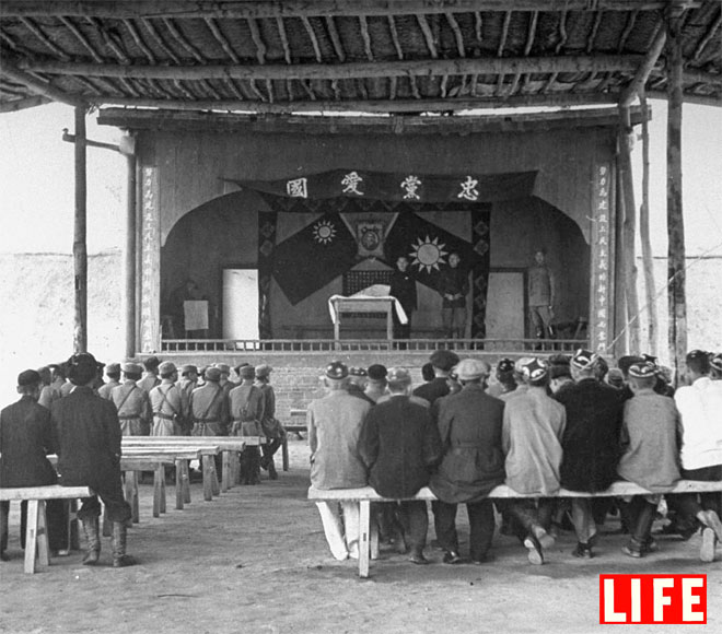 Government officials and army officers holding meeting.